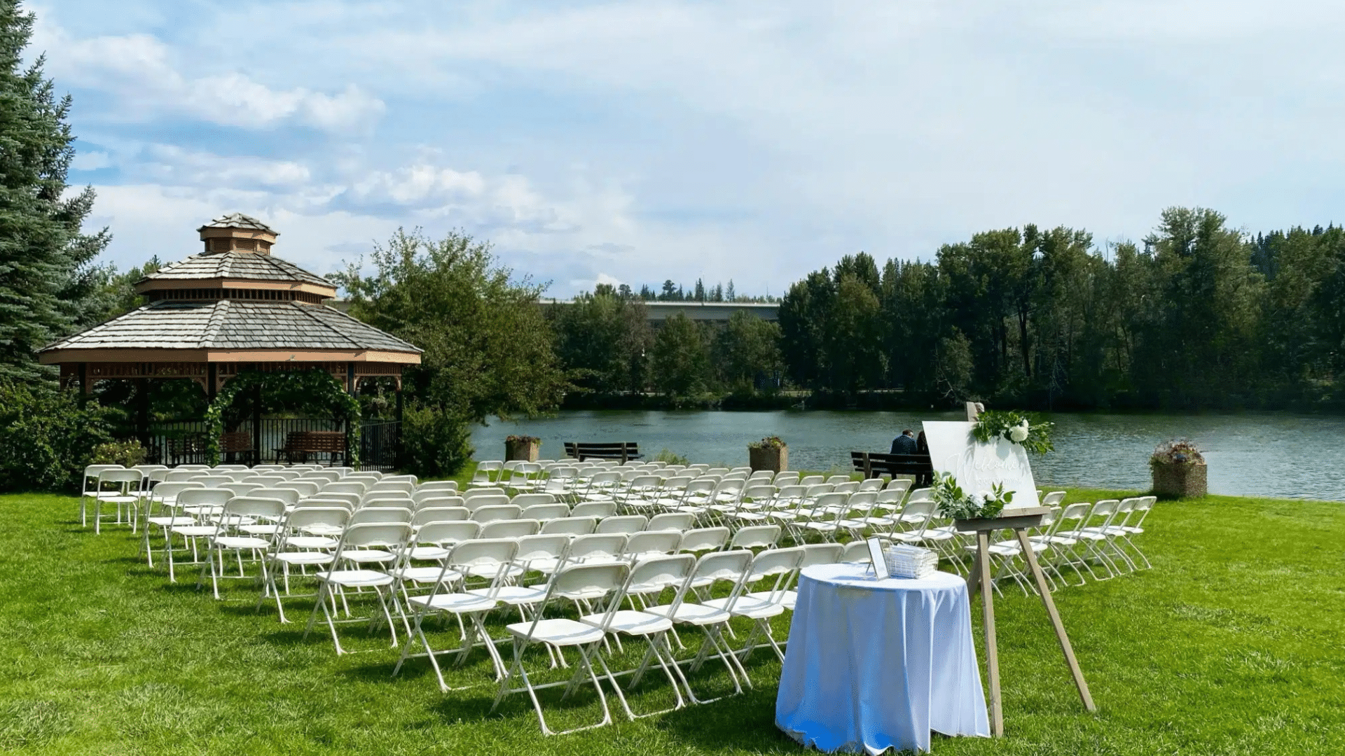 Outdoor wedding setup by Belvedere with chairs and a an entry table at Waterfront Park in Calgary