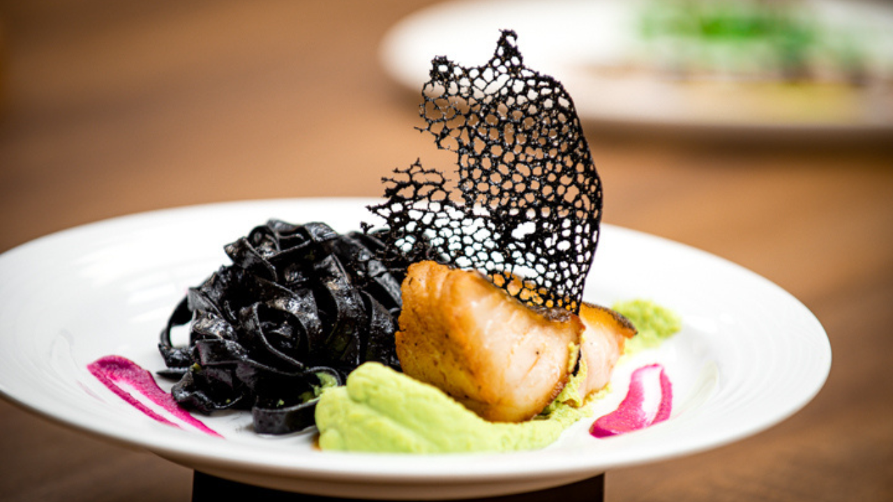 Gourmet plated entrée featuring artistic culinary presentation served during an upscale wedding reception, showcasing the fine dining standards of Simply Elegant catering.